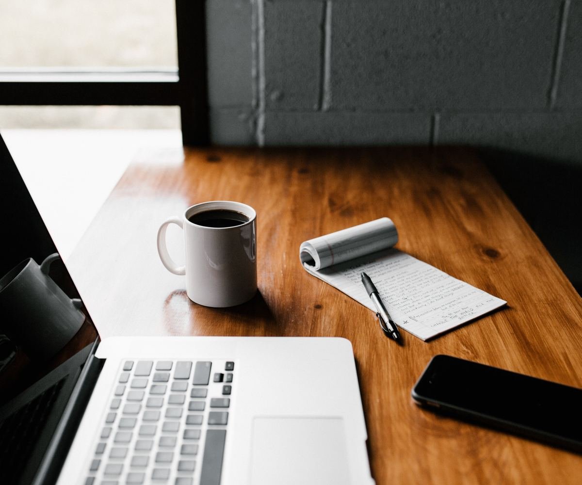 Poste de travail avec ordinateur portable, carnet de notes et téléphone